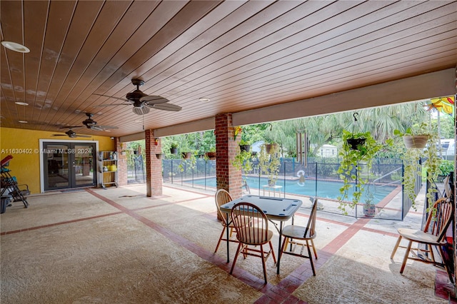 view of patio with ceiling fan and a fenced in pool