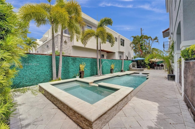 view of swimming pool with an in ground hot tub, a patio, a fenced backyard, and a fenced in pool