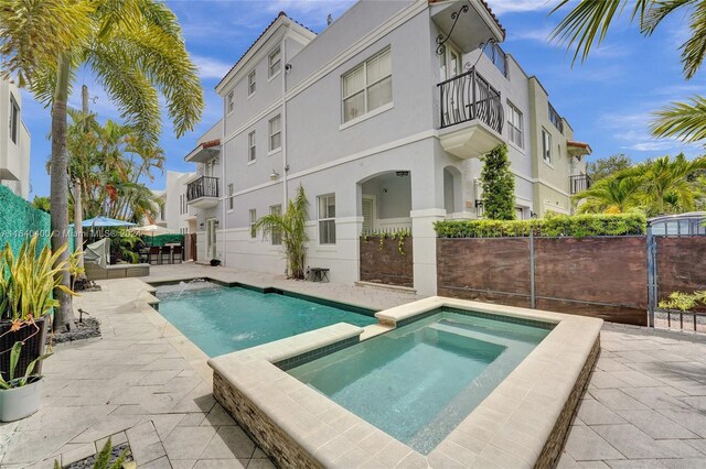 view of pool featuring an in ground hot tub and a patio area