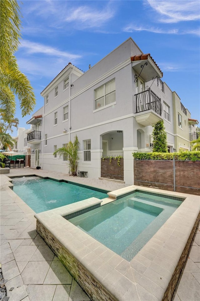 view of pool with an in ground hot tub