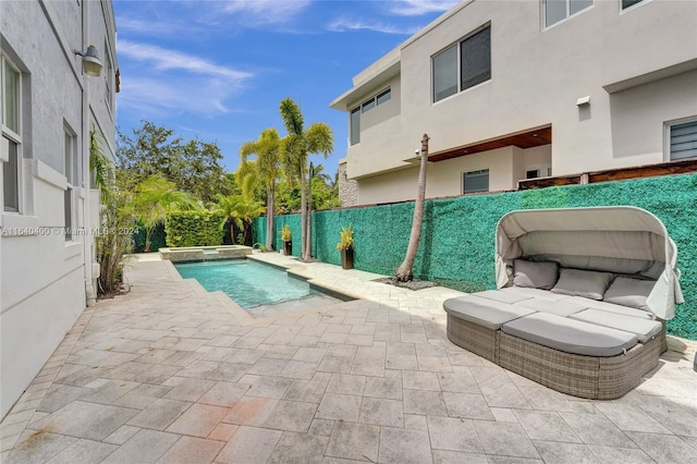 view of swimming pool with a patio area, a fenced backyard, and a pool with connected hot tub