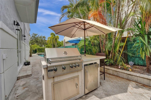 view of patio with area for grilling and an outdoor kitchen