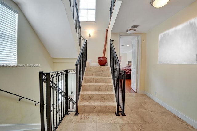 stairs with visible vents and baseboards