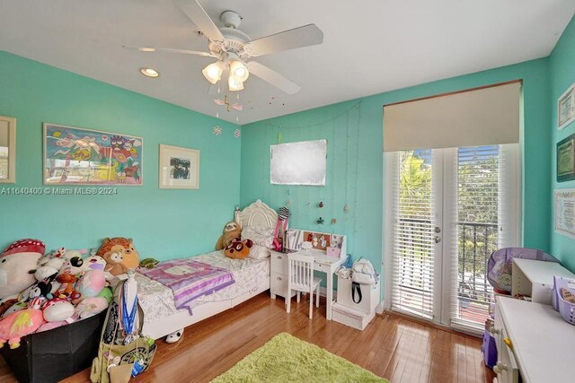 bedroom with hardwood / wood-style floors, access to exterior, and ceiling fan