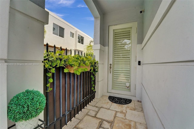 property entrance with stucco siding