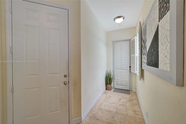 hall featuring light tile patterned flooring