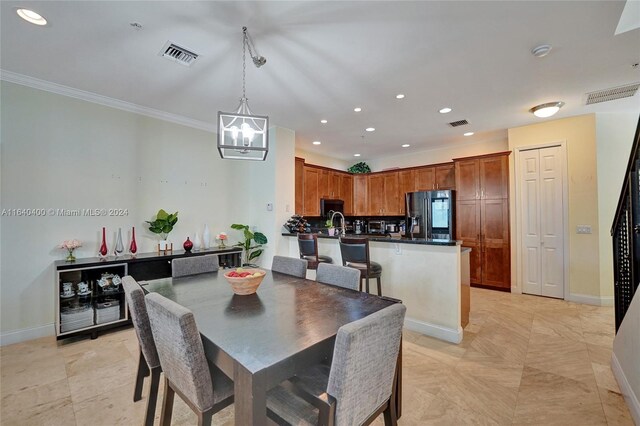 tiled dining room featuring crown molding and an inviting chandelier