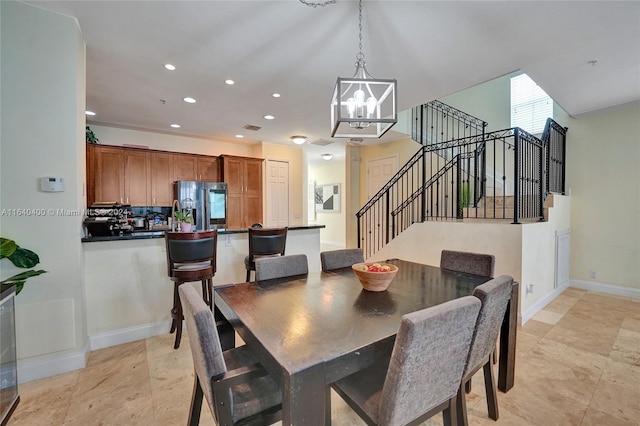 dining room with a notable chandelier and light tile patterned floors