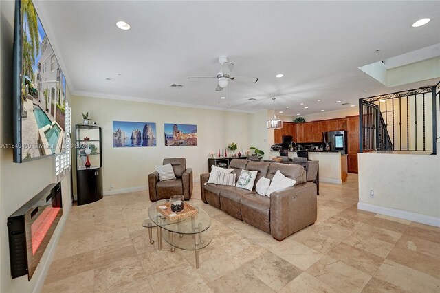 tiled living room featuring ceiling fan and ornamental molding