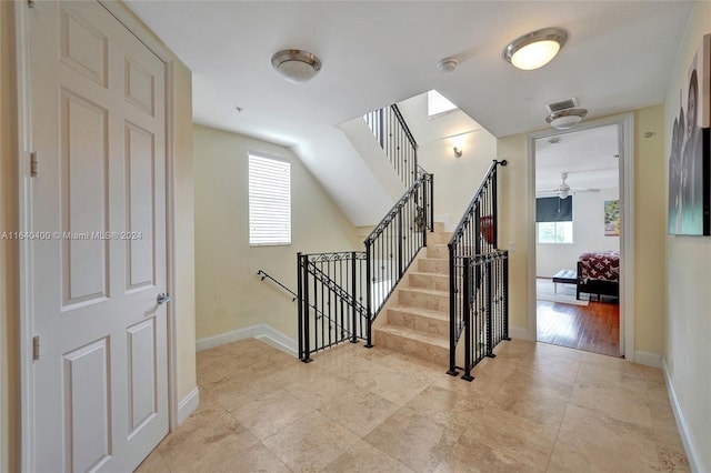 stairway featuring baseboards