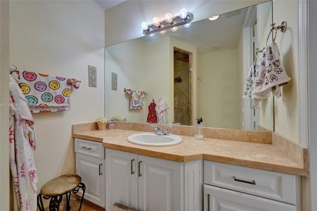 full bath featuring a shower and vanity