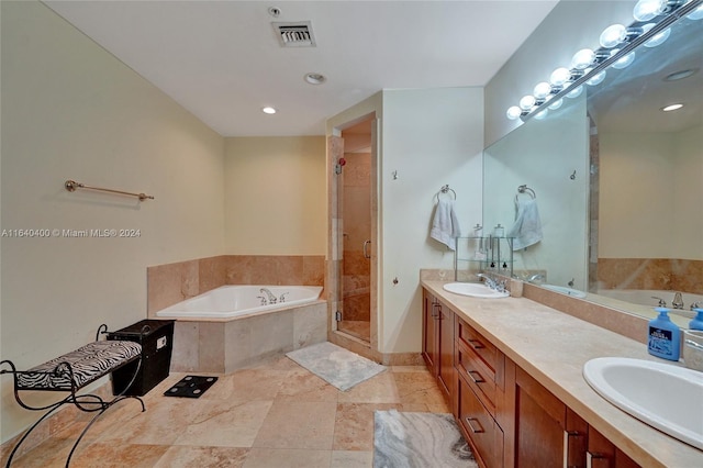 bathroom featuring double sink vanity, tile patterned floors, and separate shower and tub