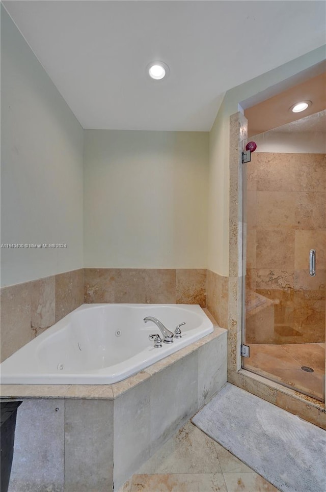 bathroom featuring tile patterned flooring and separate shower and tub