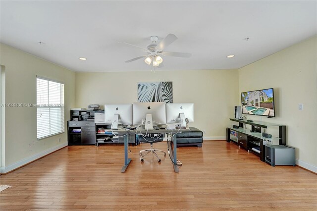 home office with ceiling fan and light wood-type flooring