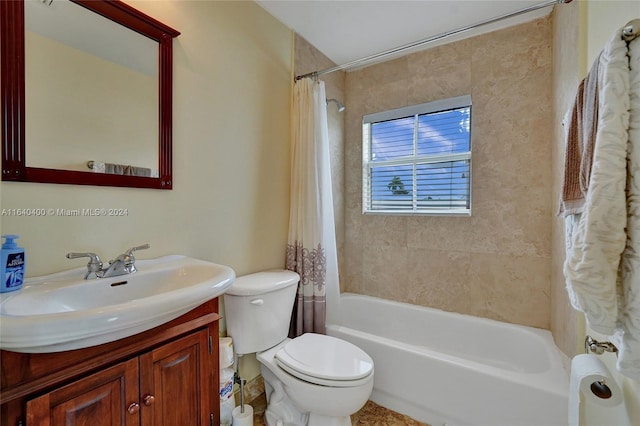 full bathroom featuring shower / bath combo with shower curtain, vanity, and toilet