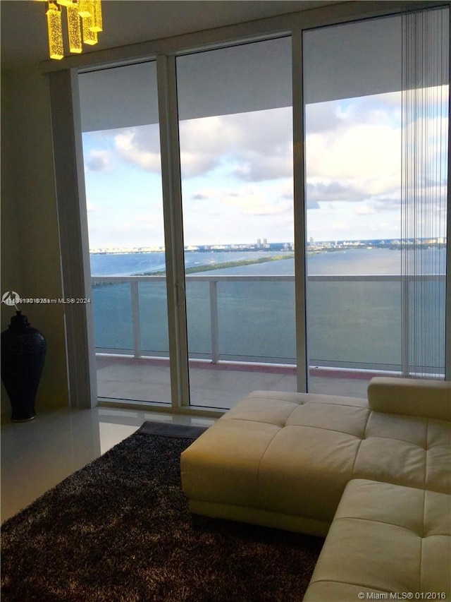 living room featuring a water view and plenty of natural light