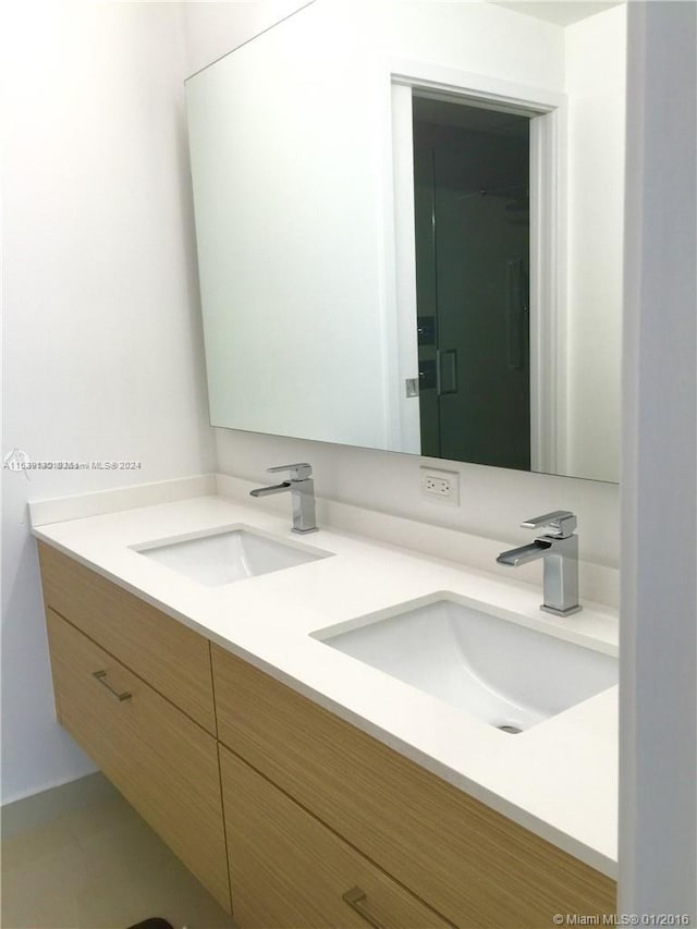 bathroom featuring tile patterned floors and double sink vanity