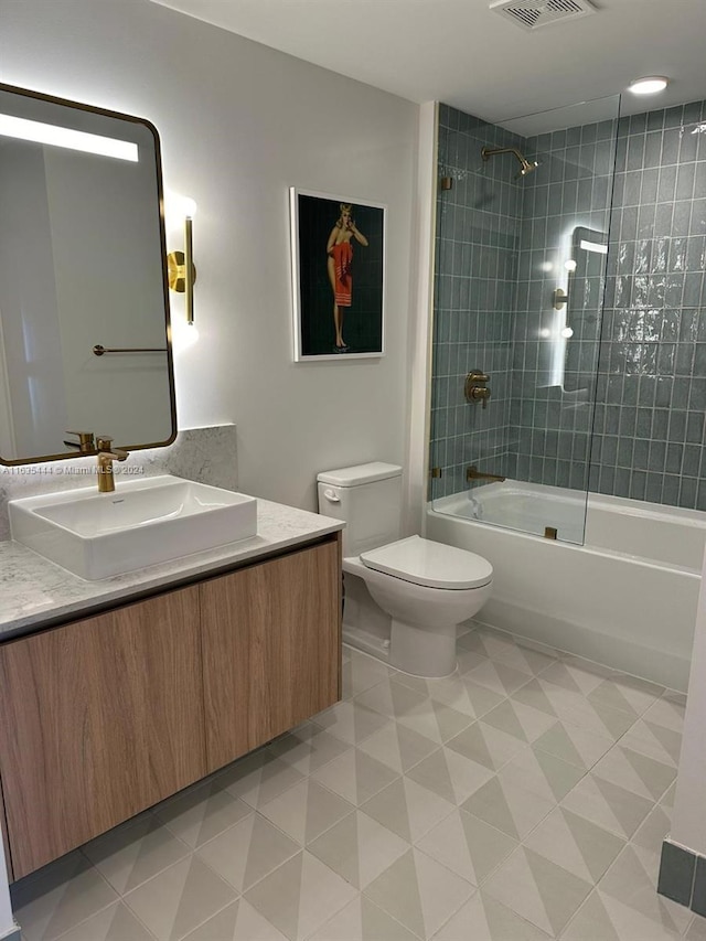 full bathroom with tile patterned flooring, vanity, toilet, and tiled shower / bath combo