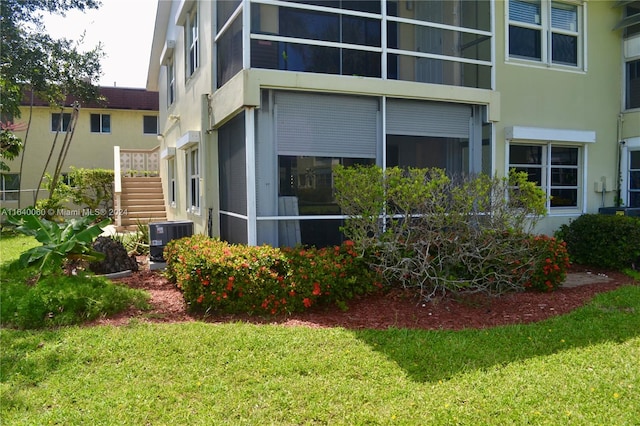 view of property exterior featuring cooling unit and a yard