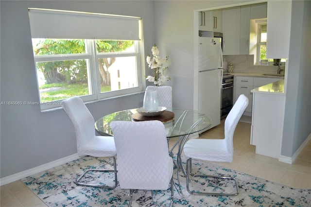 tiled dining room featuring sink