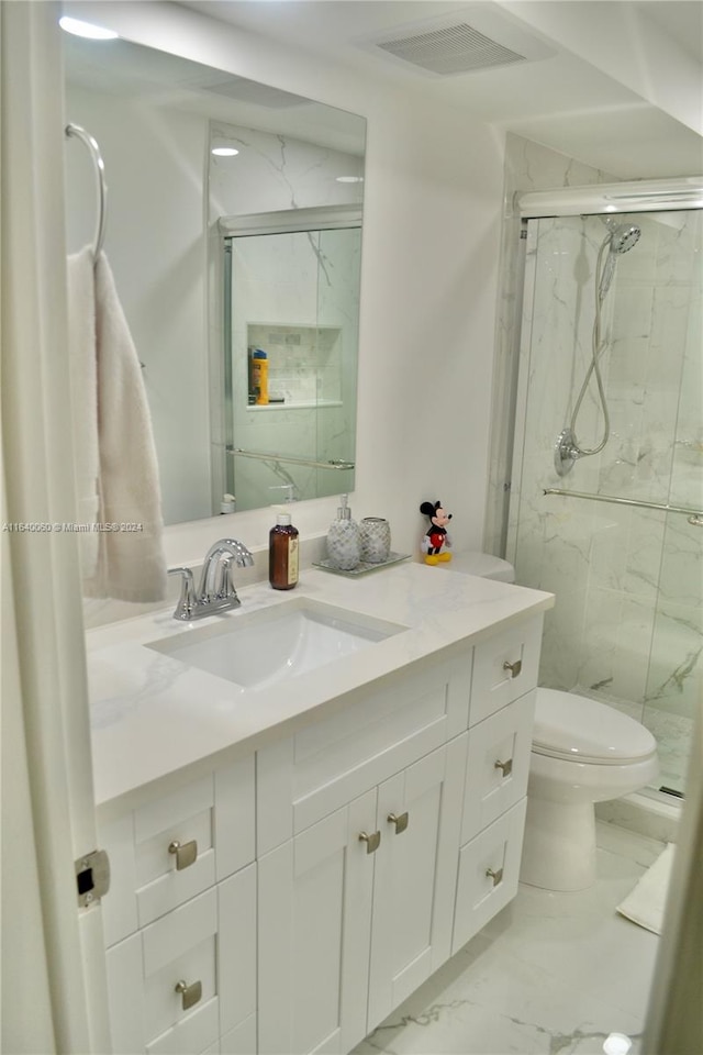 bathroom featuring vanity, toilet, tile patterned flooring, and an enclosed shower