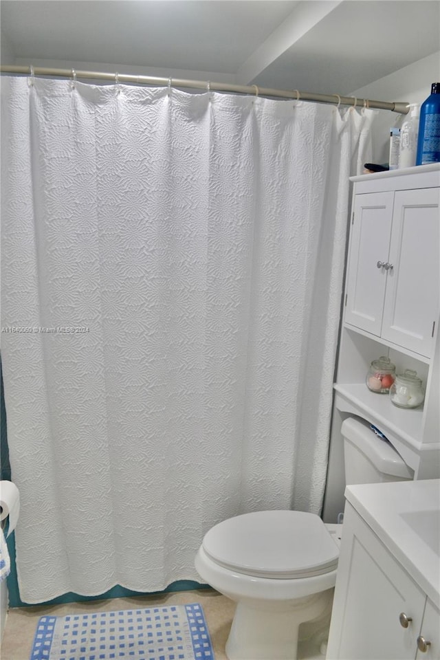 bathroom with vanity, toilet, and tile patterned flooring