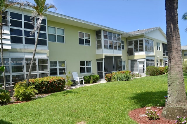 rear view of property featuring a yard