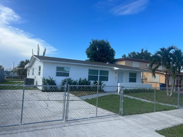 ranch-style house with cooling unit and a front yard