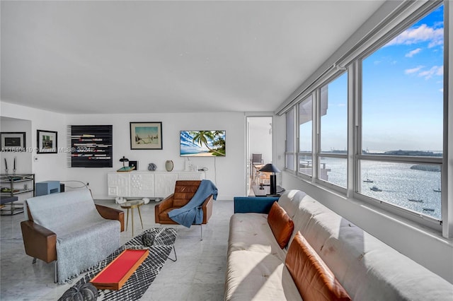 living room featuring a water view and tile patterned flooring