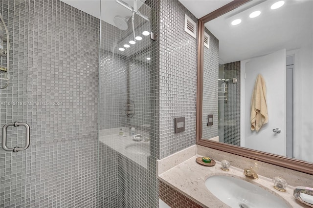 bathroom with sink and an enclosed shower