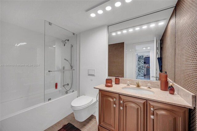 full bathroom with tile patterned floors, vanity, washtub / shower combination, and toilet