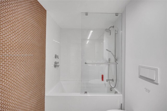 bathroom featuring tub / shower combination and toilet