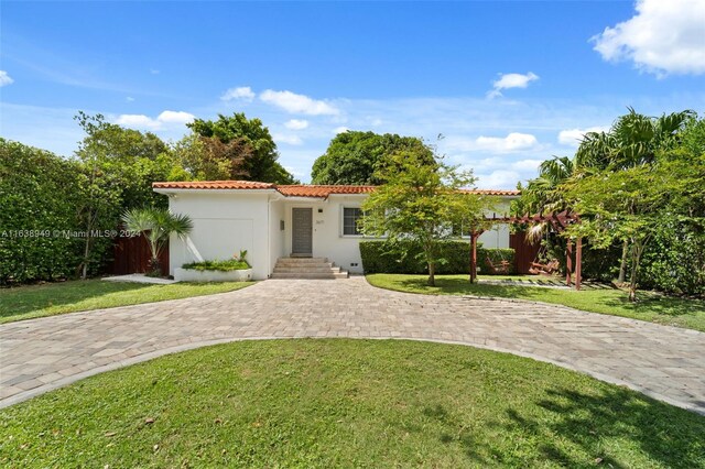 mediterranean / spanish-style house featuring a front lawn