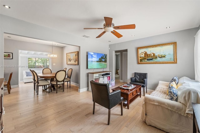 living room featuring ceiling fan and light wood-type flooring