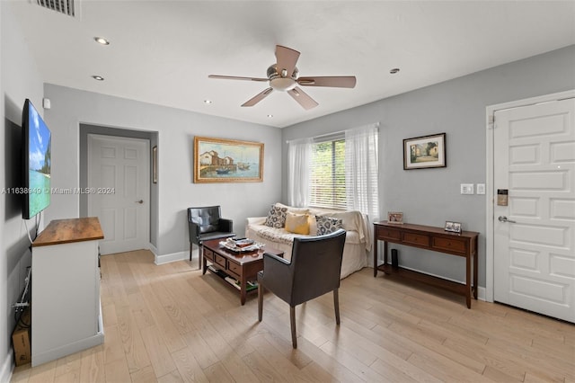 living room featuring ceiling fan and light wood-type flooring