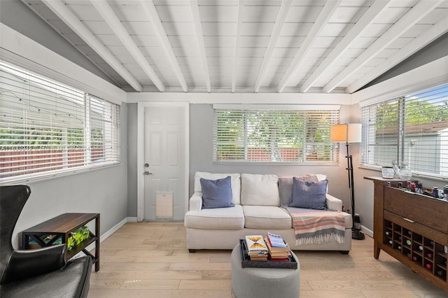 sunroom with lofted ceiling with beams