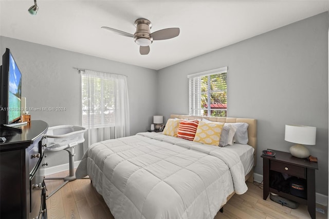 bedroom with ceiling fan and light hardwood / wood-style floors