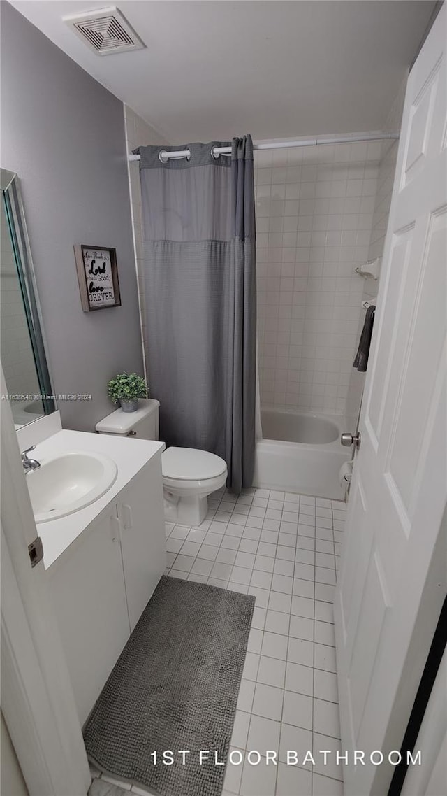 full bathroom with vanity, toilet, tile patterned floors, and shower / bath combo