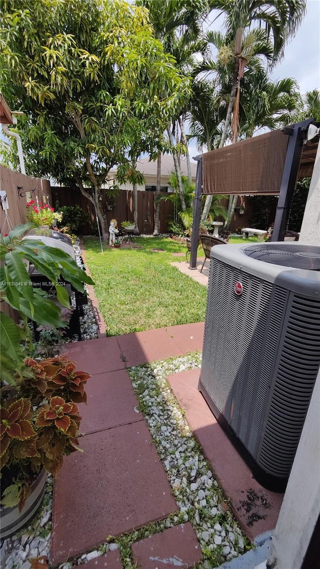 view of yard featuring cooling unit and a patio