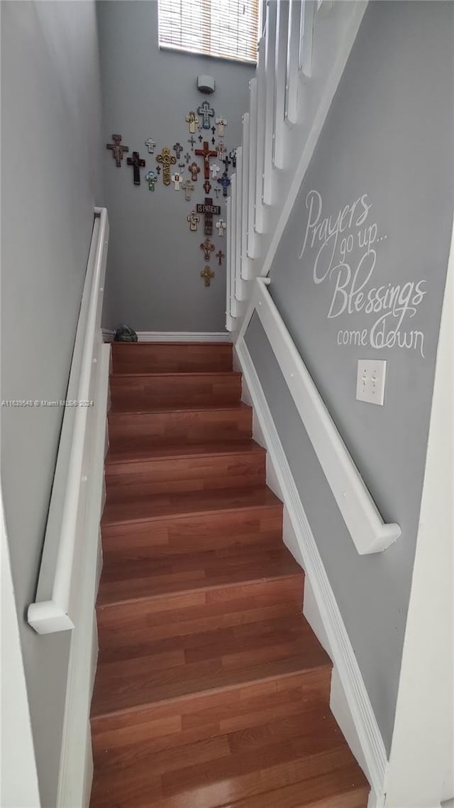 stairs with hardwood / wood-style floors