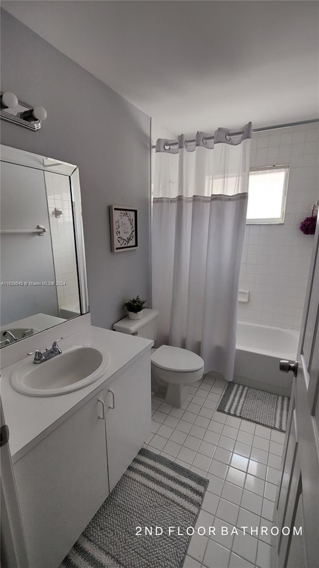 full bathroom featuring vanity, toilet, tile patterned floors, and shower / bath combo