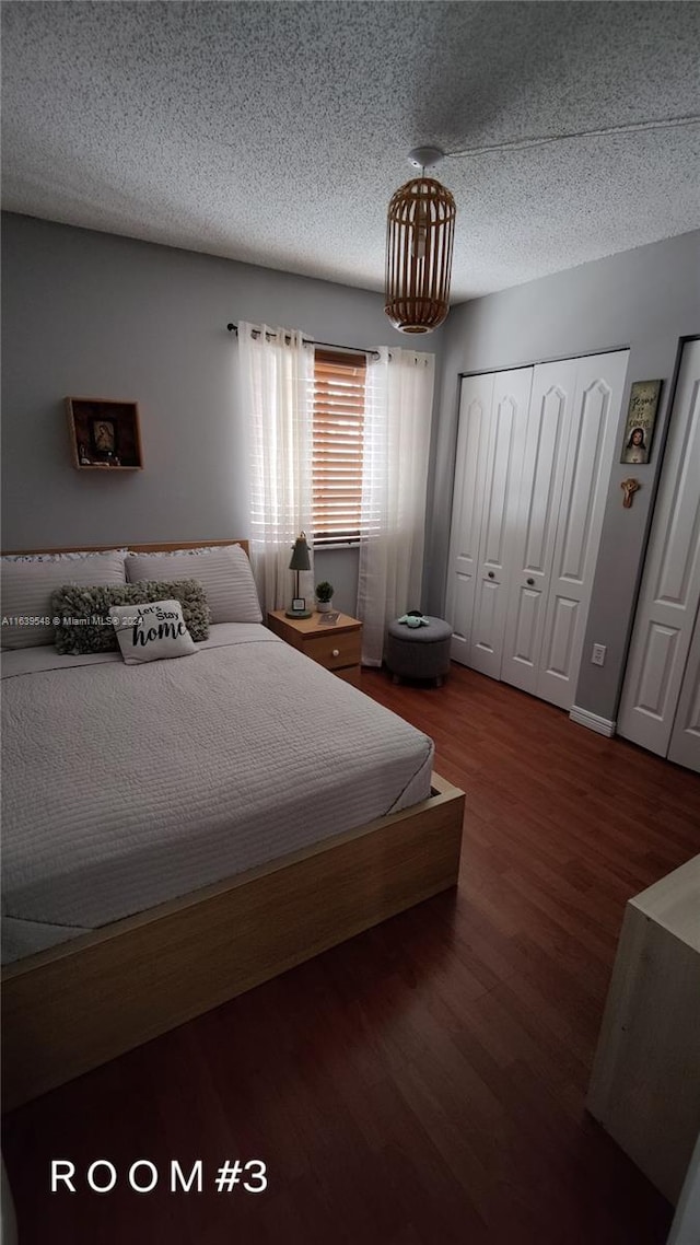 bedroom featuring a closet, a textured ceiling, and hardwood / wood-style flooring