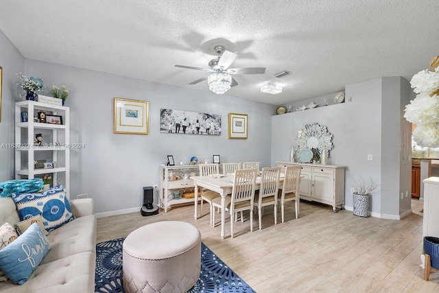 dining area featuring a textured ceiling, light hardwood / wood-style flooring, and ceiling fan