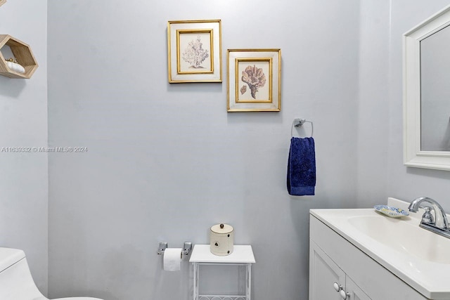 bathroom featuring toilet and vanity