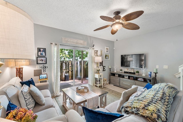 carpeted living room with ceiling fan and a textured ceiling