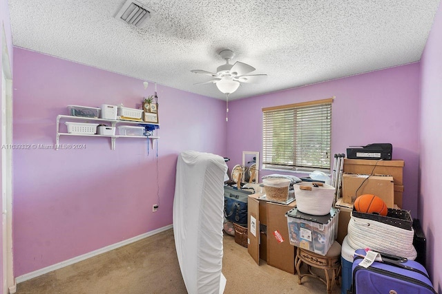 interior space with ceiling fan and a textured ceiling