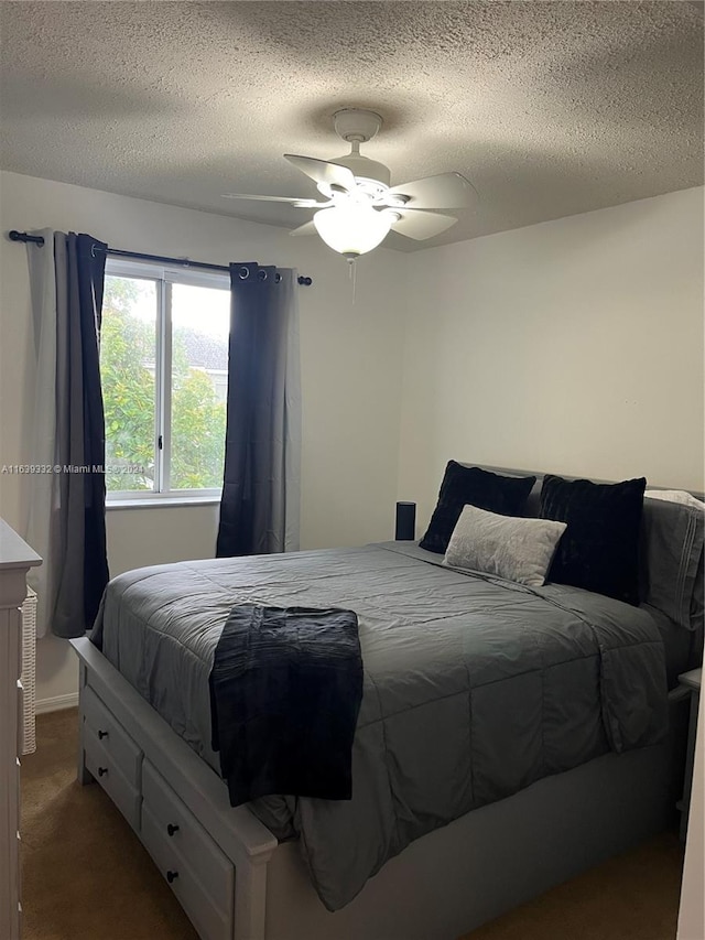 bedroom with a textured ceiling, ceiling fan, and carpet flooring