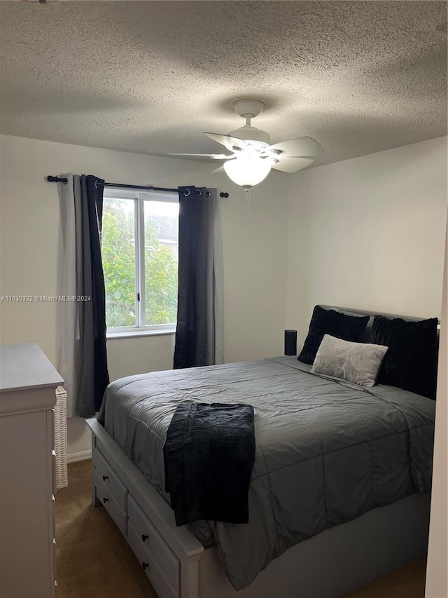 carpeted bedroom featuring a textured ceiling and ceiling fan