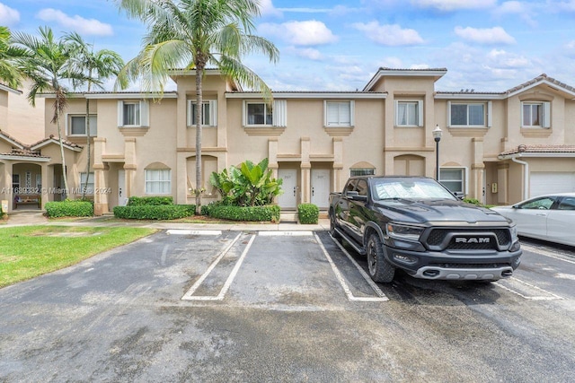 view of vehicle parking featuring a garage