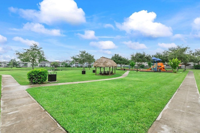 view of community featuring a playground, a lawn, and a gazebo